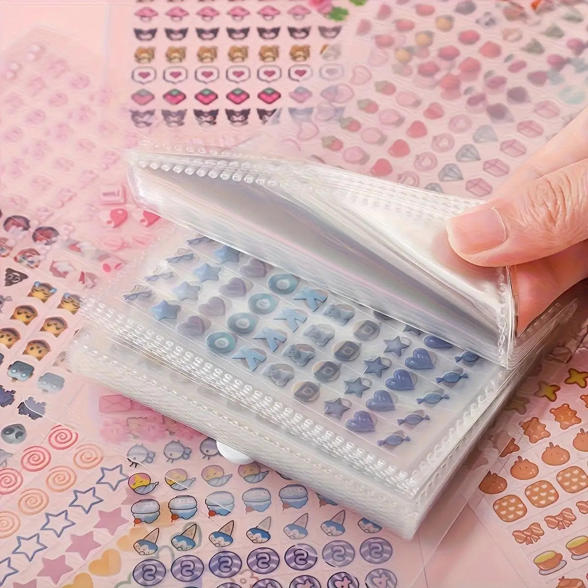 A hand holds an open storage book of 2400 mini stickers with cute patterns for journaling and scrapbooking.