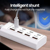 A white 8-in-1 USB wall outlet adapter with multiple ports is shown on a wooden surface.