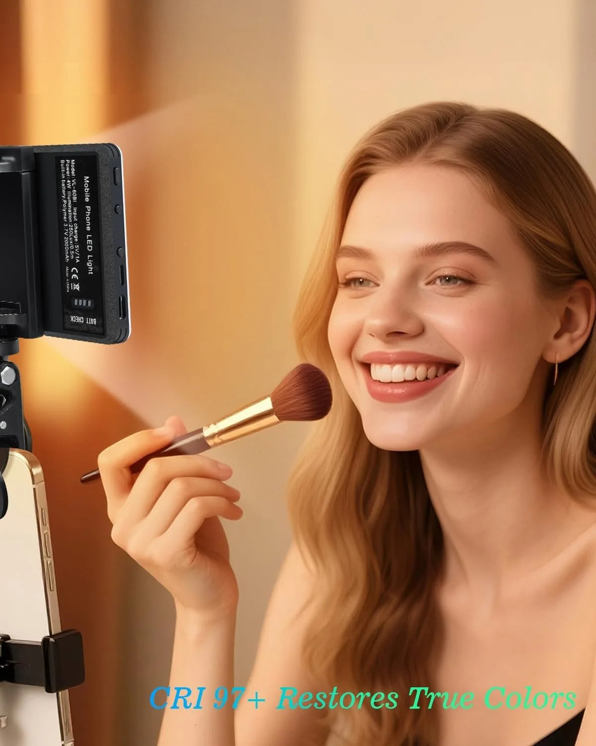 A woman applies makeup using a brush in front of a portable clip-on LED selfie light.