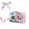 A clear plastic label maker device with pink ribbon and black ink roll visible.