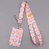 A pink heart-shaped lanyard with a repeating pattern of cute faces and hearts