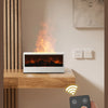 A hand holds a remote control next to an aroma essential oil diffuser emitting light and smoke in a modern interior.