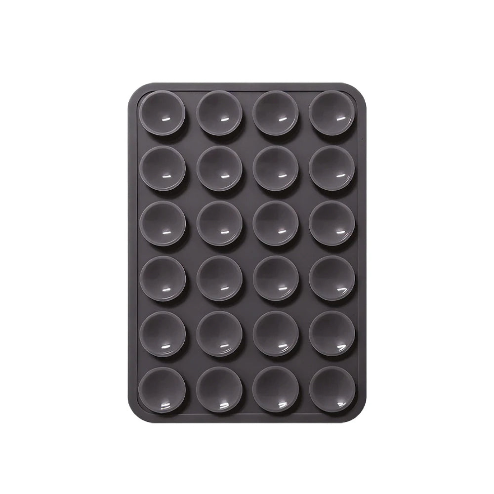 Sujetador de teléfono de silicona negra con múltiples orificios circulares para montar dispositivos.