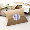 A brown kraft paper thank you card with a circular iridescent sticker that reads Thank You for supporting my small business