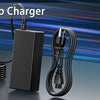 A black HP 65W laptop charger with a coiled cable is displayed on a dark surface.