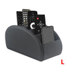 A gray PU leather caddy organizer holding a smartphone and three TV remotes.