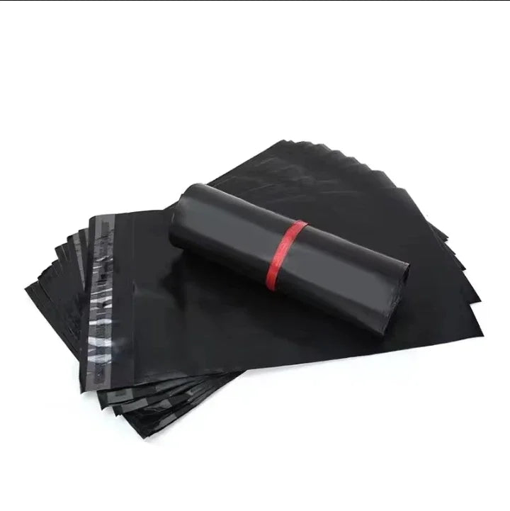 Stack of black self-adhesive sealing storage bags with a rolled bag on top