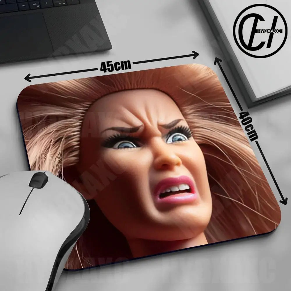 A close-up of a mouse pad featuring a realistic doll face design with long brown hair and an intense expression.