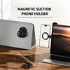 A magnetic suction phone holder mount is shown with a laptop and a smartphone on a wooden desk.