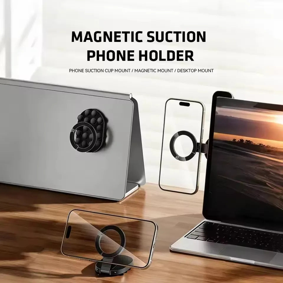 A magnetic suction phone holder mount is shown with a laptop and a smartphone on a wooden desk.