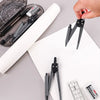 A hand holds a set of professional drafting tools including a compass and a pair of dividers on a white sheet of paper.