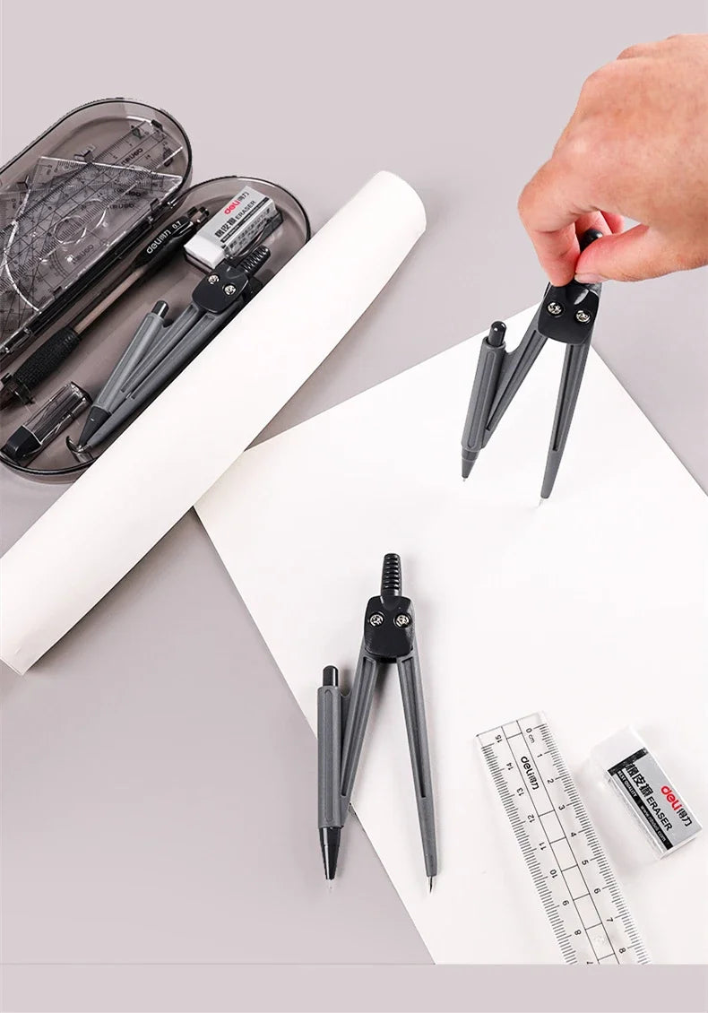 A hand holds a set of professional drafting tools including a compass and a pair of dividers on a white sheet of paper.