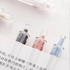 A close-up view of five smooth writing gel pens with black ink, arranged on a white surface.