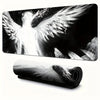 Black and white artistic image of an angel wing on a desk mat or mouse pad