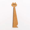 A wooden drawing ruler shaped like a cute cartoon cat, used for measuring.