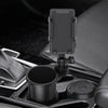 A black universal car cup holder mount with a 360-degree rotating phone holder installed in a vehicle interior.