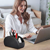 A woman is smiling while working on a laptop next to a black PU leather remote control holder with five compartments.