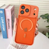 An orange magnetic wireless charging lens protector case for an iPhone is held against a background of books.