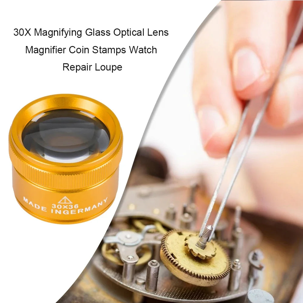 A close-up of a gold-colored 30X magnifying glass optical lens used as a repair loupe for watches and coins.
