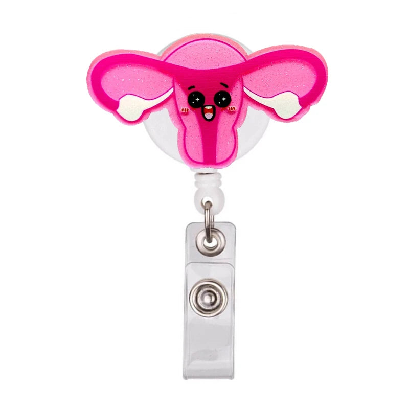 Pink cartoon elephant medical badge reel holder with a clear dome and silver clip.