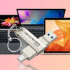 A silver USB 3.0 pen drive with a keyring is shown next to a laptop displaying a colorful background.