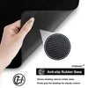 Hand holding a black anti-slip rubber base for a gaming mouse pad
