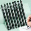 A set of black precision gel pens with silver accents, arranged diagonally on a light green surface.