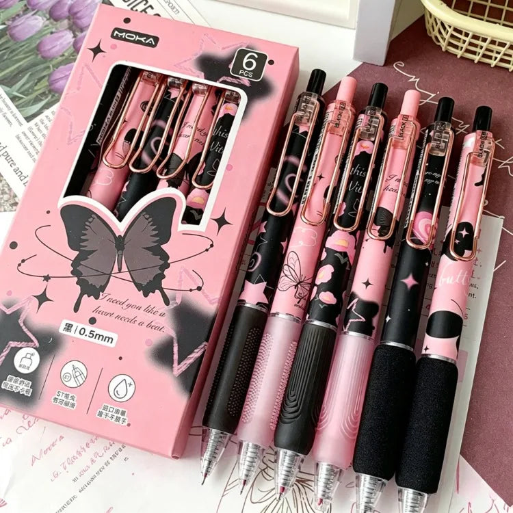 A set of six pink and black butterfly design gel pens is displayed in a box.