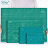 A green SiRo cutting mat with grid guides and a matching mat shown next to a person's hands.