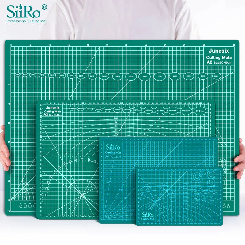 A green SiRo cutting mat with grid guides and a matching mat shown next to a person's hands.