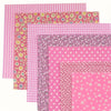 A collection of pink cotton patchwork fabric squares featuring various floral, polka dot, and star patterns.