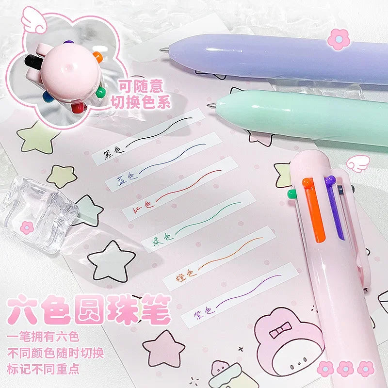 A set of six colored pencils and a purple pen are displayed on pink paper with color gradient lines.