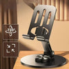 A black 360 degree rotating mobile phone holder mounted on a wooden surface.