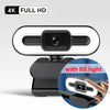 A black 4K Full HD webcam with a built-in fill light and microphone mounted on a stand.