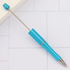 A silver and blue DIY beadable pen set with a metal tip resting on a white surface.