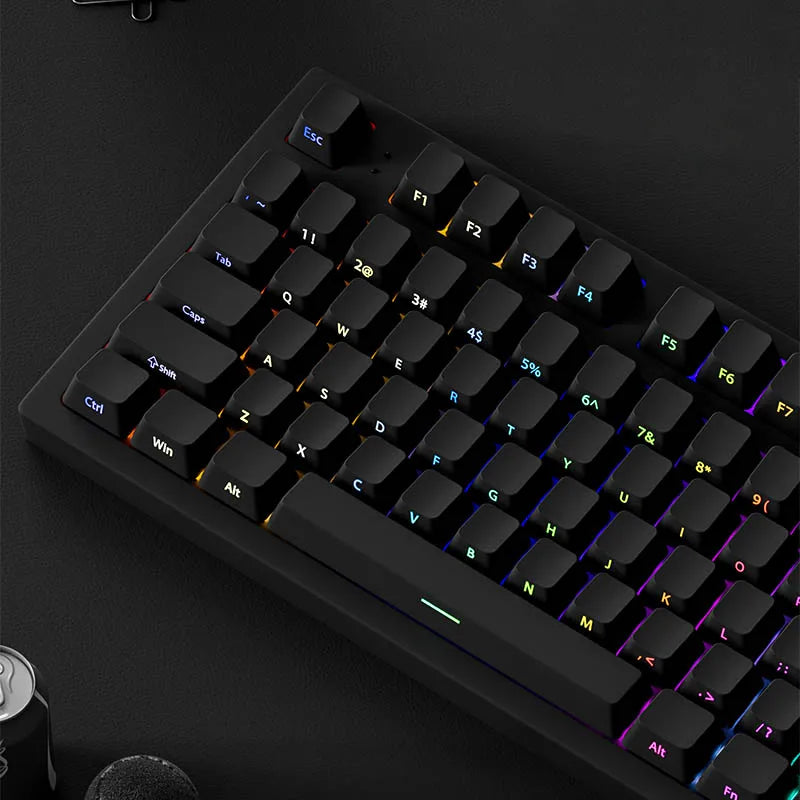 A close-up view of a black mechanical keyboard with PBT double-shot cherry profile keycaps and RGB lighting.