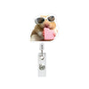 A funny hamster wearing sunglasses holding a pink acrylic item on an acrylic badge reel.