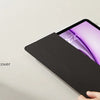 A black magnetic folio case for an iPad is shown being opened and closed on a light surface.