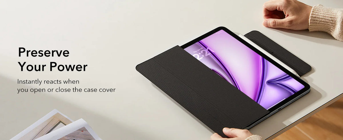 A black magnetic folio case for an iPad is shown being opened and closed on a light surface.