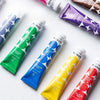 A collection of Meeden gouache paint tubes in various colors including green, blue, yellow, and red
