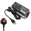 Black AC adapter cable and plug for a laptop, with technical specifications printed on the adapter box.