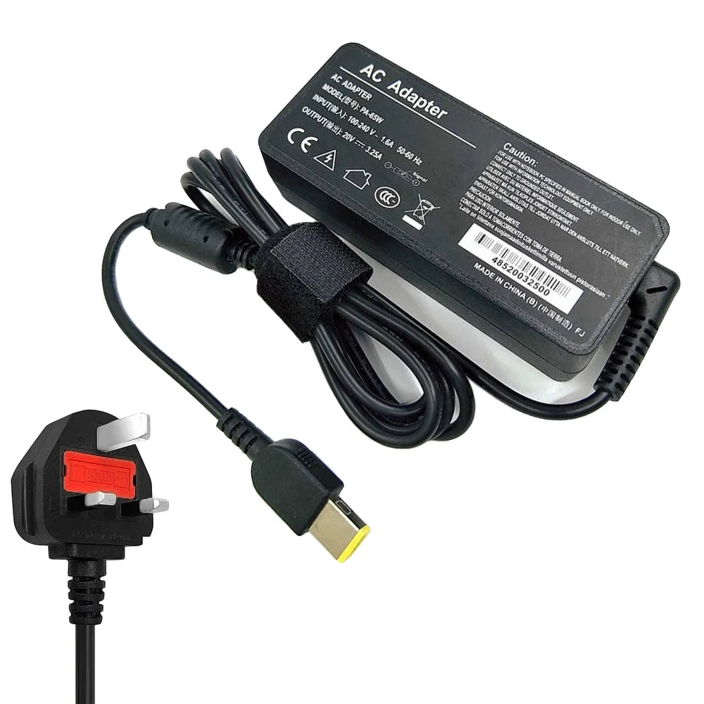 Black AC adapter cable and plug for a laptop, with technical specifications printed on the adapter box.
