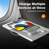 A white magnetic wireless power bank with built-in cables is shown charging multiple devices on an airplane window ledge.