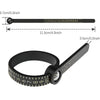 A black ring sizer and measuring tool with a magnifier showing various sizes.