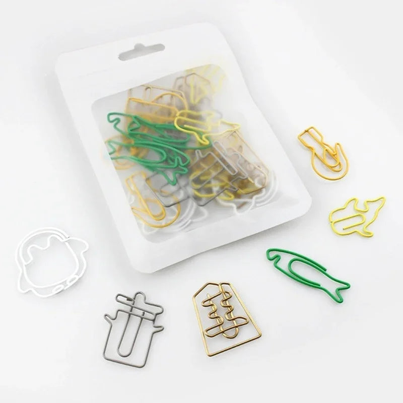 A clear plastic container holds a set of colorful decorative bookmarks and paper clips.