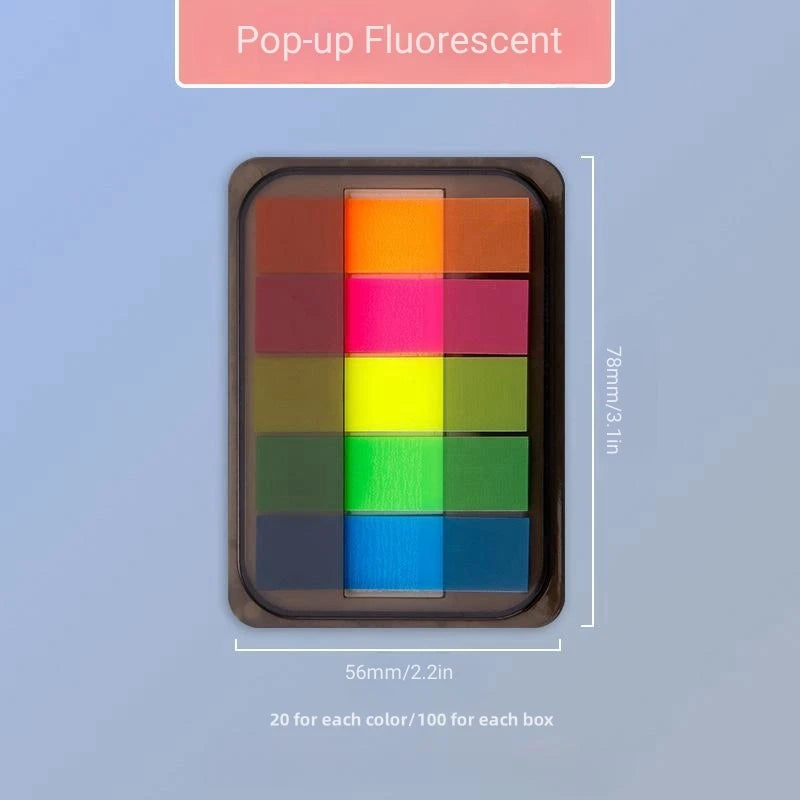 A box of Pop-up Fluorescent sticky notes showing various bright colors arranged in a grid.