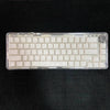 A close-up view of a clear plastic case containing side-lit cherry profile mechanical keycaps for custom keyboards.