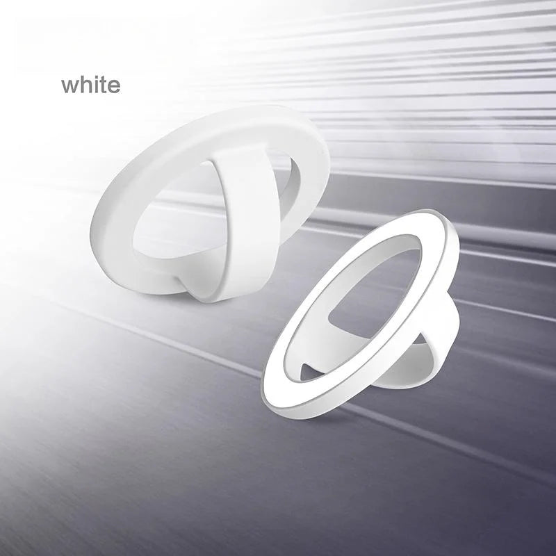 A white magnetic silicone phone grip with a foldable stand shown in various angles.
