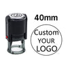 A black self-inking stamp with a clear cylinder, featuring text and a space for a custom logo.