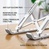 A white adjustable foldable laptop cooling stand featuring anti-slip silicone pads and a stable triangular structure on a woo